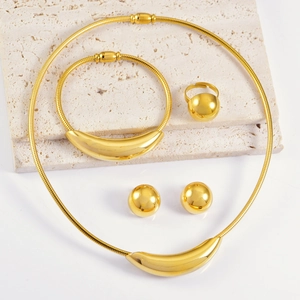 Luxurious gold jewelry set with curved collar necklace, bracelet, ring and stud earrings