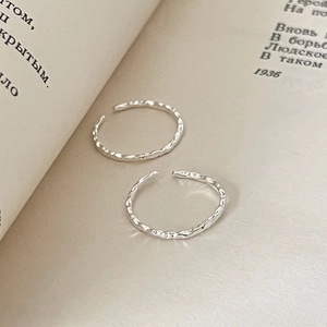 S925 sterling silver open rings with hammered texture displayed on an open book