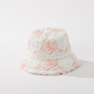 Detail of white plush bucket hat featuring decorative pink 3D fabric rose flower petals