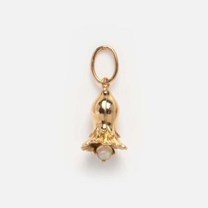 Detail of golden flower bud pendant featuring a white birthstone pearl on a clean background