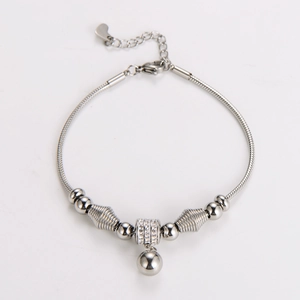 Detail of silver snake chain bracelet with polished beads and rhinestone pendant charms