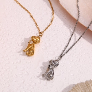 Close-up of dog-shaped necklaces in gold and silver finish with sparkling stones