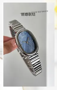 Close-up of GEDI women's watch featuring an oval silver case and blue brushed dial