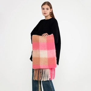 Pink and beige plaid tassel scarf made of soft warm cashmere-like fabric worn by model