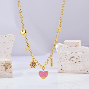 Close-up of golden chunky chain necklace with colorful enamel charms and Amour tag