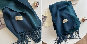 Detail of navy blue imitation cashmere scarf with tassels and stitched woven label