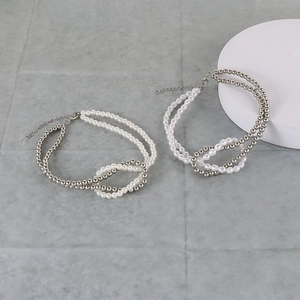 Detail view of double-layered pearl and silver bead necklace with adjustable lobster clasp