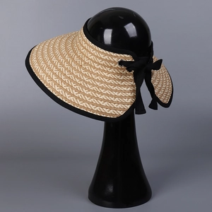 Japanese style straw sun hat with wide brim and black bow detail on mannequin