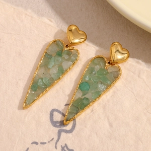 Detail of 18K gold heart earrings featuring unique green crushed stone inlay texture