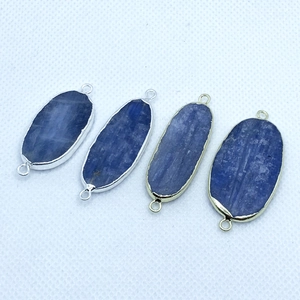 Detailed view of natural kyanite stone connectors with gold and silver plated frames