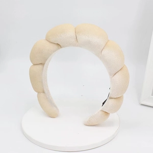 Detailed texture of braided velvet headband in cream white with a soft padded design