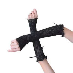 Detail of cross-armed model wearing black lace arm sleeves with elegant bow accents