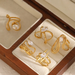 Luxury gold stainless steel zircon ring set with marquise stones on a wooden jewelry box
