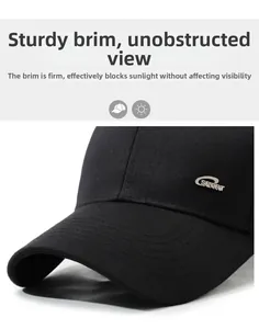 Close-up of black baseball cap featuring a polished silver SPORT metal logo on the side
