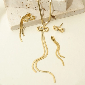 Golden stainless steel jewelry set featuring a bow necklace and matching bow earrings