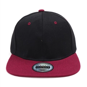 Detail of black and burgundy snapback hat with flat brim and silver laser sticker
