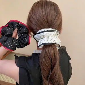 Polka dot fabric scrunchies with contrast edging in black and white styles