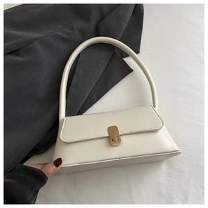 Detail view of cream white PU leather underarm bag featuring a golden square metal lock