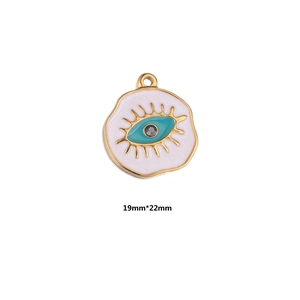 Detailed view of evil eye charm in gold and white enamel with 19mm by 22mm dimension