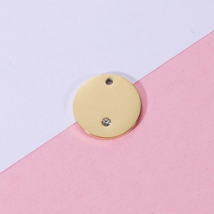 Polished gold circular stainless steel pendant with crystal inlay and hanging hole