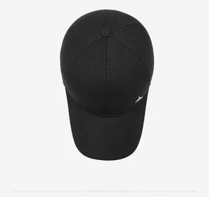 Top view of a black winter baseball cap showing textured fabric and silver metal emblem