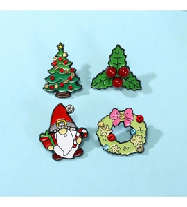 Set of four Christmas enamel pins including a tree, holly, gnome, and festive wreath