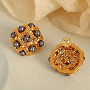 Elegant woven mesh texture titanium earrings with inlaid grey pearls in golden finish