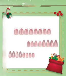 Detail of Christmas press-on nails with white snowflakes, glitter and French tips
