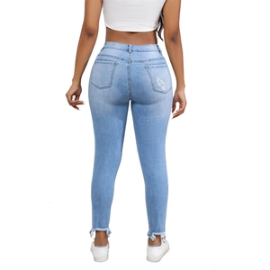 Women's light blue slim fit denim jeans with high waist and raw hem details