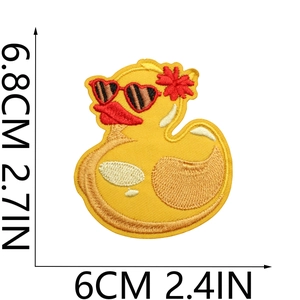 Close-up of yellow duck embroidered patch with red sunglasses showing 6.8cm size