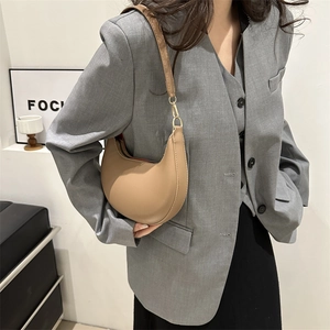 Retro khaki crescent shoulder bag in PU leather for women, shown on a stylish model