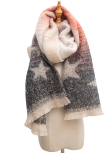Detail of thick knit scarf with star pattern, orange-grey gradient, and fringe finish