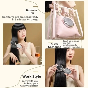 Close-up of portable folding hairbrush with mirror tucked inside a clear handbag