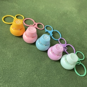 Fidget toy mechanical keycap keychain in five pastel colors with pixelated cartoon faces