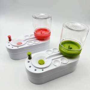 Detail view of portable paintbrush cleaner with red and green bases and spring mechanism