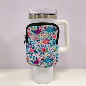 Detailed close-up of a floral neoprene pouch attached to a white 40oz tumbler