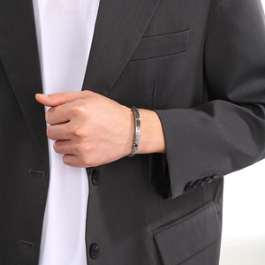 Close-up of men's stainless steel dragon bone bracelet with classic Greek key pattern