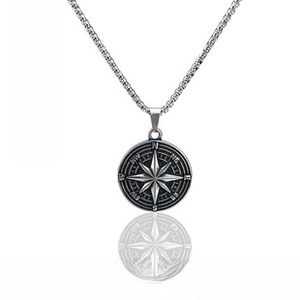 Detailed macro view of vintage compass pendant with octagonal star and steel box chain