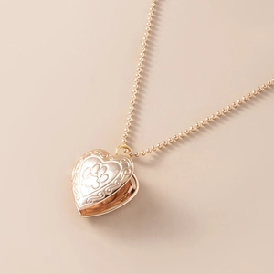 Golden heart locket necklace with footprint pattern on a delicate ball chain