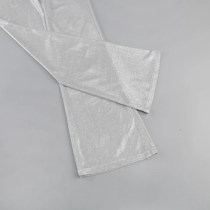 Close-up of sparkling silver sequin fabric texture on high-waist straight pants