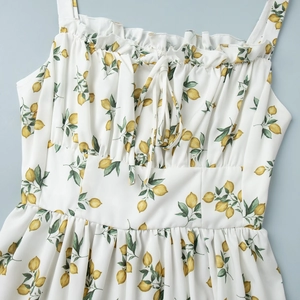 Detail of floral sundress with lemon print, ruffle neckline and drawstring front
