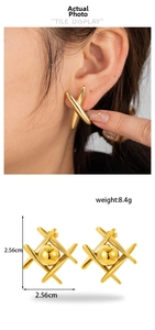 Detail view of gold geometric cross earrings with inner ball showing dimensions and fit
