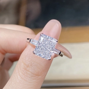 Macro view of a classic three-stone S925 silver ring with radiant cut ice flower diamond