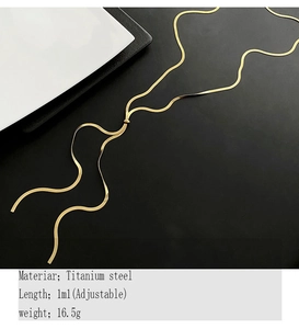 Detailed view of adjustable golden titanium steel snake chain over black background