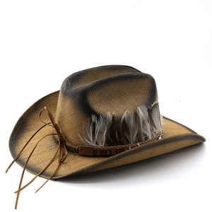 Close-up of woven straw cowboy hat with natural feathers and vintage gradient brim edges
