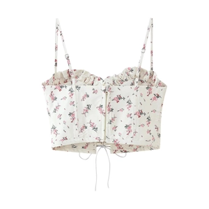 Close-up of white floral camisole top with adjustable straps and front zipper detail