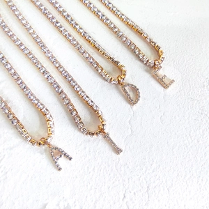 Golden letter pendant necklace with sparkling cubic zirconia on a minimalist chain