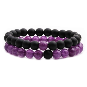 Matte black stone and translucent purple amethyst beaded bracelets on white background