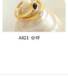 Macro shot of U-shaped gold ring with black and white pearl stones on spiral stand