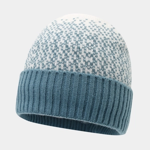 Detailed knit texture of a blue and white patterned beanie with vertical ribbed cuff